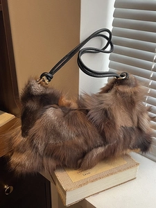 Chic patchwork faux fur underarm bag with plush brown and black textures and leather straps