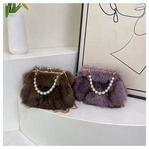 Detail of luxury fox fur handbags featuring white pearl handles and gold chain straps