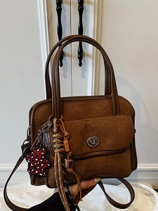 Vintage brown suede bowling bag with large capacity, top handles, and crossbody strap