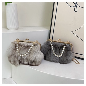 Close-up of plush fox fur crossbody bags with pearl chains in grey and khaki