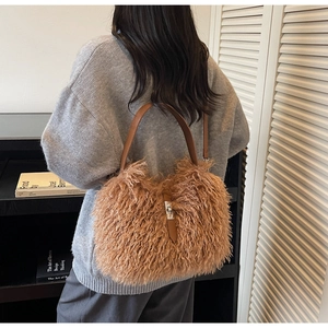 Close-up of fluffy faux fur bucket bag with leather handle and silver swivel lock clasp