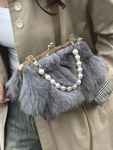 Gray faux fox fur crossbody bag with pearl handle and gold kiss-lock closure