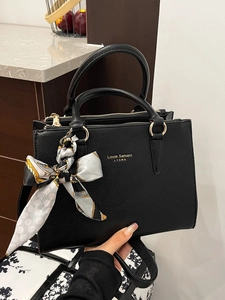 Black leather tote bag with lychee texture, golden logo, and elegant printed silk scarf