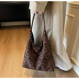 Close-up of leopard print shoulder tote bag paired with a beige trench coat