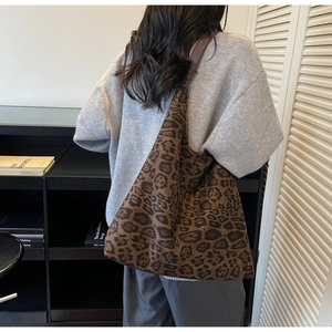 Detailed shoulder view of a large leopard print tote bag in soft textured knit fabric