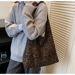 Leopard print tote bag shown on shoulder with large capacity and stylish chic design