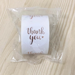 Macro shot of 3.8cm rose gold Thank You stickers in transparent roll packaging