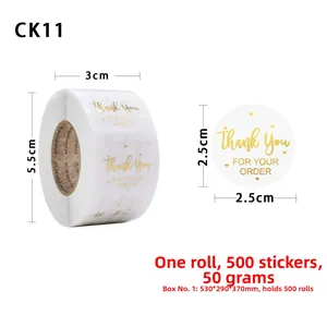 Macro detail of 2.5cm gold foil Thank You stickers on a roll for bakery packaging