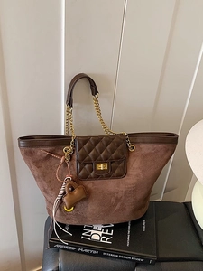 Brown suede tote bag with quilted front pocket, gold chain strap, and large capacity