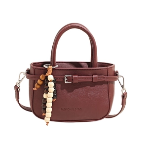 Minimalist burgundy faux leather handbag with twin handles and wooden bead tassel