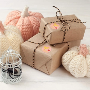 Pink and gold Thank You seal stickers on craft gift box with autumn decor accents