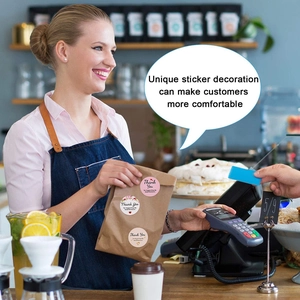 Floral Thank You For Supporting My Small Business stickers on a paper coffee bag