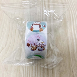 Close-up of Christmas roll stickers with snowman and reindeer patterns in packaging