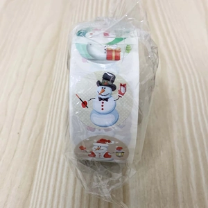 Detailed view of Christmas snowman stickers in a roll for gift wrapping and DIY crafts