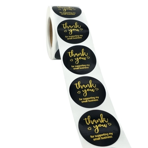 Roll of 1 inch round black thank you stickers with gold foil for small business packaging