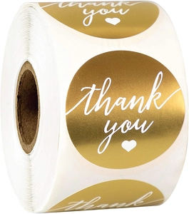 Close-up of 1.5-inch gold foil thank you stickers in a roll for gift packaging