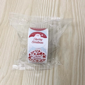 Close-up of Merry Christmas sticker roll with festive Santa and snowflake patterns