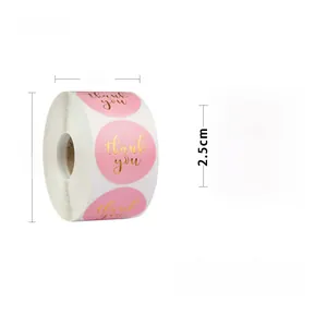Detailed view of a 1-inch pink thank you sticker roll with 500 gold foil labels
