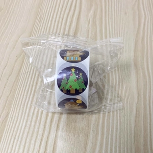 Detailed macro view of a 2.5cm Christmas roll sticker pack with festive tree motifs
