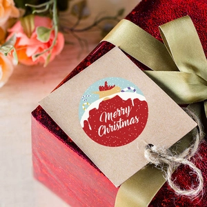 Round Merry Christmas sticker roll for gift packaging with festive red holiday patterns