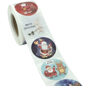Roll of 500 Merry Christmas stickers featuring cartoon Santa and reindeer for gift decor