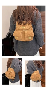 Detailed views of brown quilted suede mini backpack with golden chain and twist locks