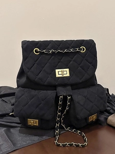 Quilted black mini backpack with gold twist locks and chain straps in vintage style
