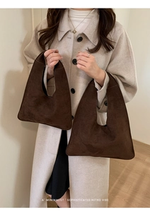 Detail showing high-quality chocolate suede texture and slouchy drape of the tote bags