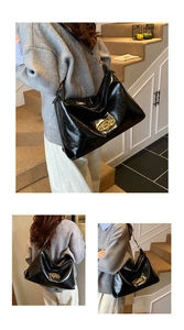 Close-up of black glossy leather bag with golden metallic oval planetary brand plate