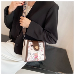 Detail of crossbody bag with colorful bear graffiti and wide printed shoulder strap
