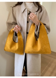 Close-up of a mustard yellow suede tote bag set showing texture and minimalist retro design