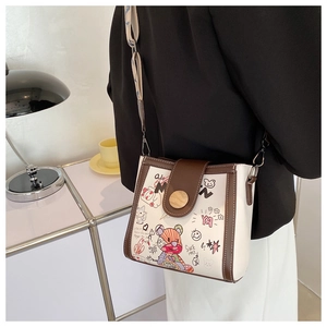 Fashion crossbody bag with cartoon bear graffiti and wide shoulder strap shown on model