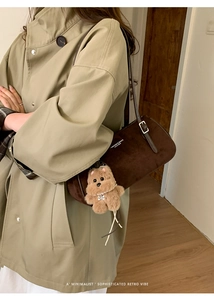 Brown suede baguette shoulder bag with leather strap and plush bear charm detail