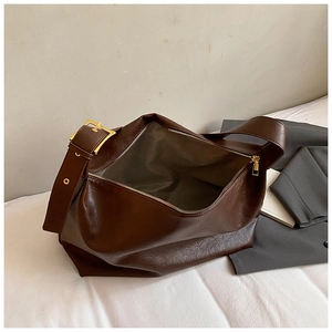 Top view of dark brown faux leather tote bag with gold buckle strap and zipper detail