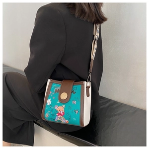 Detail of crossbody bucket bag with bear graffiti prints and stylish wide shoulder strap