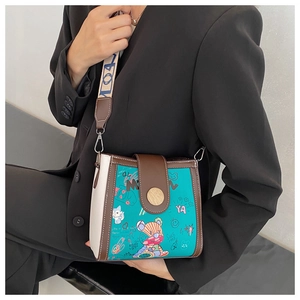 Detail of the colorful graffiti bear print and retro metal clasp on the crossbody bag