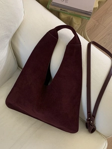 Minimalist burgundy suede hobo bag with wide handle and adjustable strap for daily commute