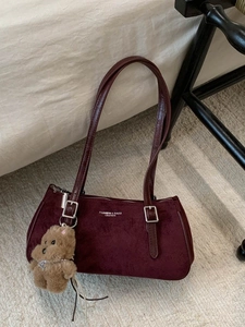 Vintage burgundy baguette shoulder bag in matte finish with a plush bear charm accessory