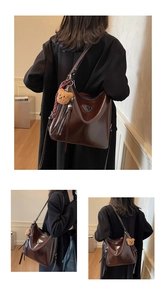 Deep brown glossy tote bag with teddy bear charm and red plaid ribbon detail