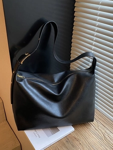 Minimalist black soft PU leather tote bag with wide shoulder strap and gold hardware