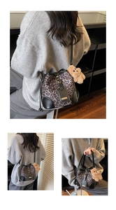 Close-up of leopard print bucket bag with leather base and cute brown teddy bear charm