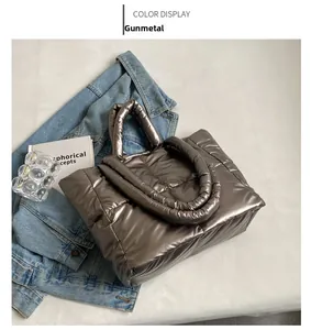 Macro detail van de gunmetal puffer tote bag met gewatteerde vierkante stiksels en glanzende afwerking
