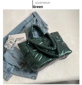 Detail van groene metallic gewatteerde puffer tote tas met grote ruiten en zachte handgrepen