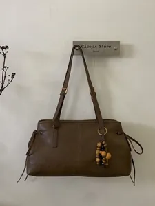 Retro dark brown faux leather tote bag with shoulder straps and boho bead pendant