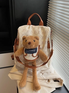 Fashionable cream backpack with all-over bear print and large plush 3D teddy bear charm