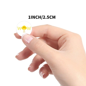 Round white toy sticker featuring a cute yellow chick and WOW text in 1 inch size