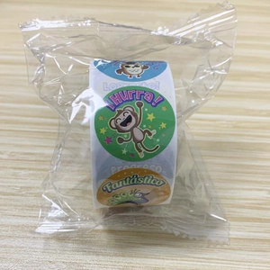 Close-up of Spanish reward stickers featuring cute cartoon animals on a wooden desk