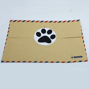 Self-adhesive pet paw print sticker on kraft envelope with red and blue stripes