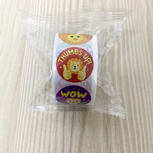 Close-up of a roll of colorful cartoon reward stickers in clear plastic packaging