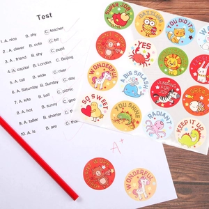 Roll of cartoon animal reward stickers with encouraging English phrases on wooden background
